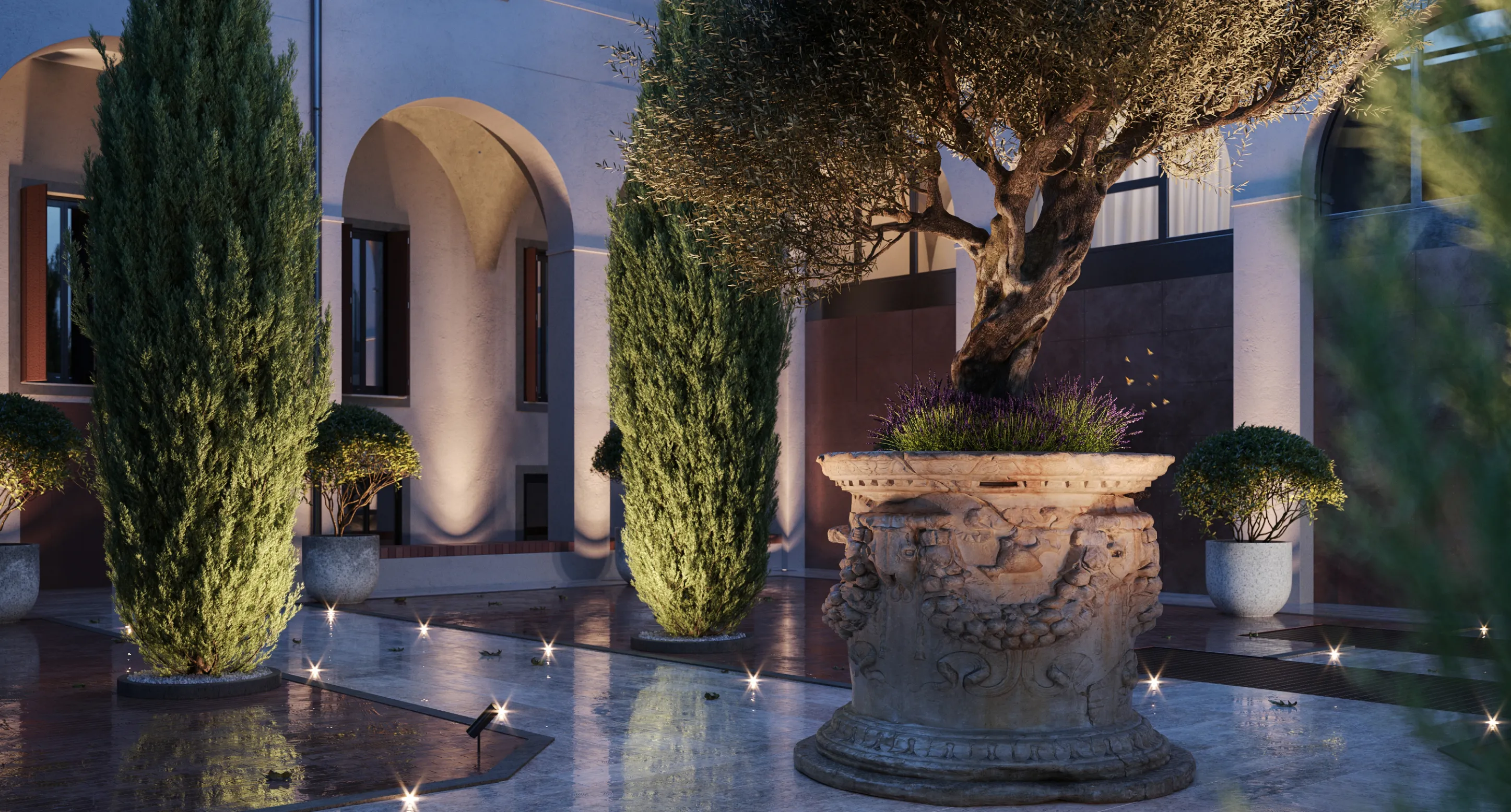 Giardino notturno con piante illuminate, un albero in un grande vaso decorato e un edificio con archi sullo sfondo.